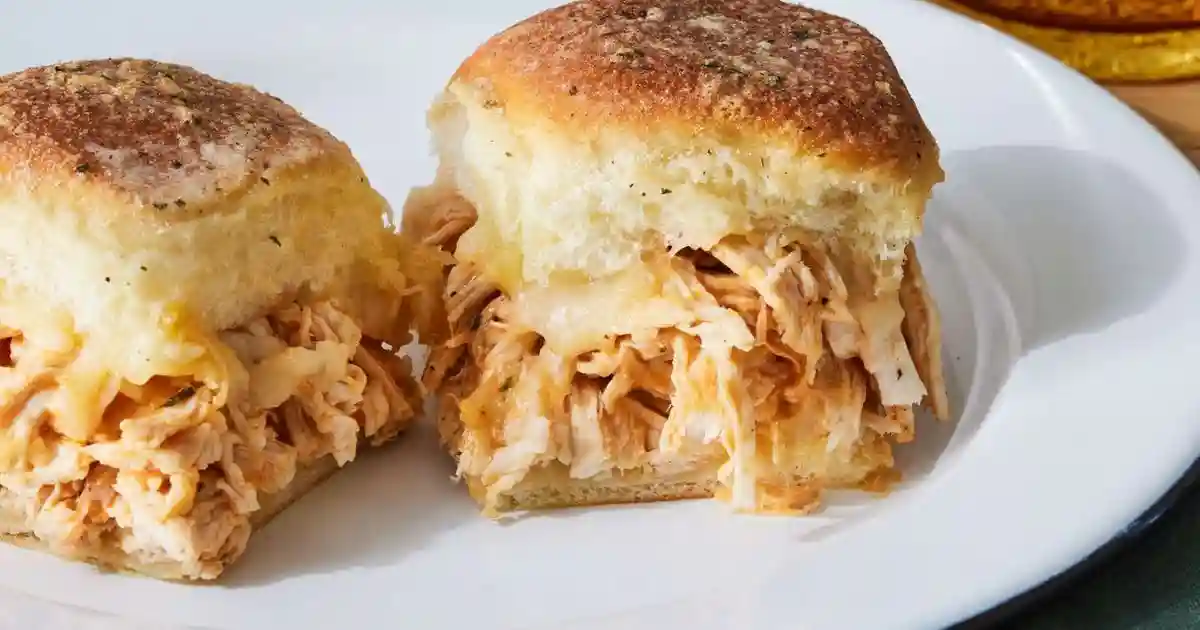 Close-up of buffalo chicken sliders recipe with melted cheese and buffalo sauce on soft slider buns.